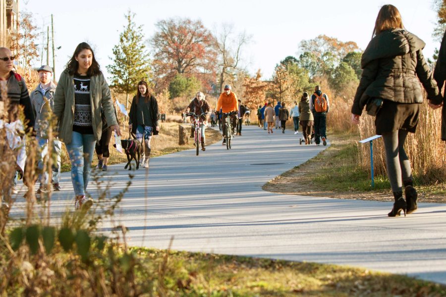 People walking along outdoor pathway
